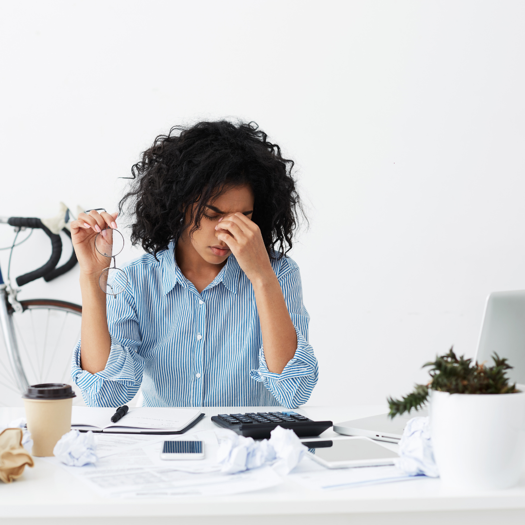 A woman with a concerned expression holding her hand due to debt collection services.